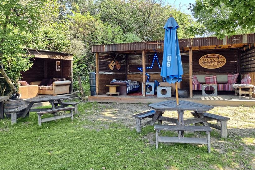 The outside dining area with benches, sofas and arm chairs