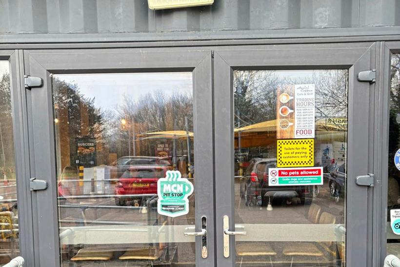 Entrance to Amici Coffee showing MCN Pit Stop sticker on the door