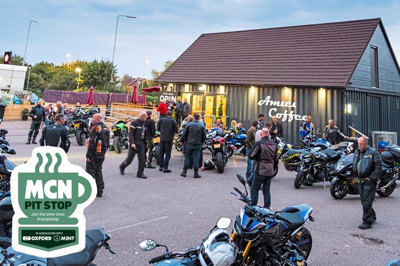 Lots of people and motorcycles outside the parking lot of Amici Coffee
