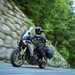 2025-on Yamaha Tracer 9 GT+ riding down a tree lined canyon road