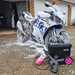 Muc-Off's mobile pressure washer, being used to clean a motorbike
