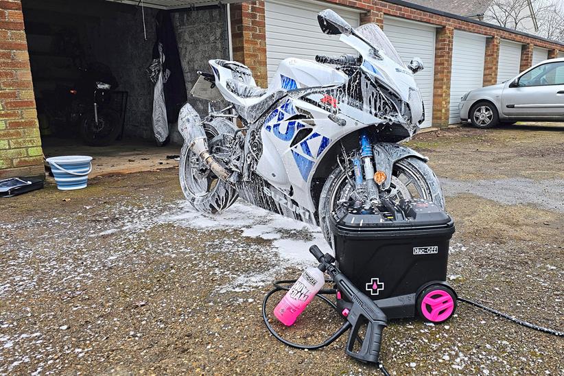 Muc-Off's mobile pressure washer, being used to clean a motorbike