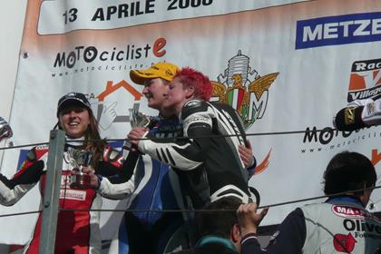 Susie Grayson celebrates on the podium in Misano