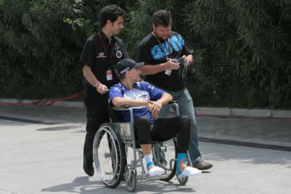 Fiat Yamaha's Jorge Lorenzo is being pushed around the MotoGP paddock in a wheelchair