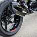 2025-on BMW R1300R detailed shot of the exhaust and rear wheel