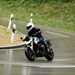 2025-on BMW R1300R carving corners on a wet road