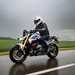2025-on BMW R1300R cruising down a wet road