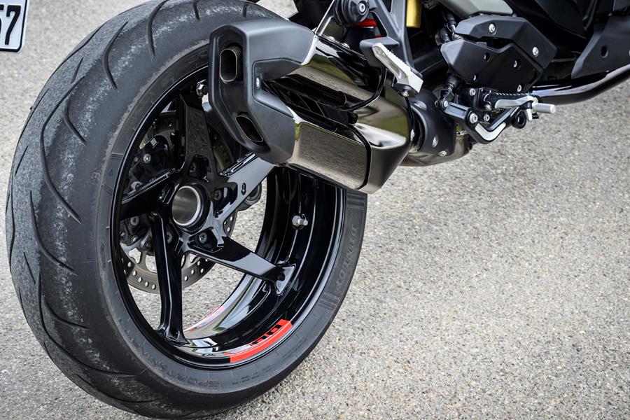2025-on BMW R1300R detailed shot of the exhaust and rear wheel