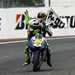 Valentino Rossi gets a lift on his own bike from Angel Nieto after he equalled his record of 90 MotoGP wins at the Le Mans race