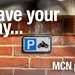 Motorcycle parking sign on a wall
