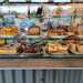 Cake display on the counter with all it's prices