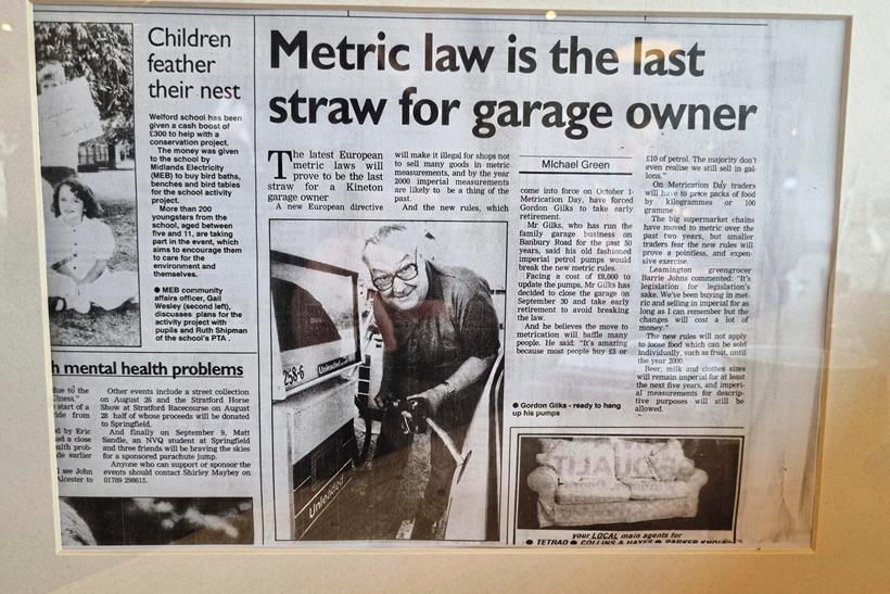 An old article about the garage in black and white on display on the wall. 