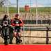 Two riders watching from trackside