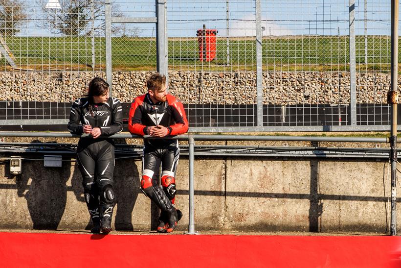 Two riders watching from trackside
