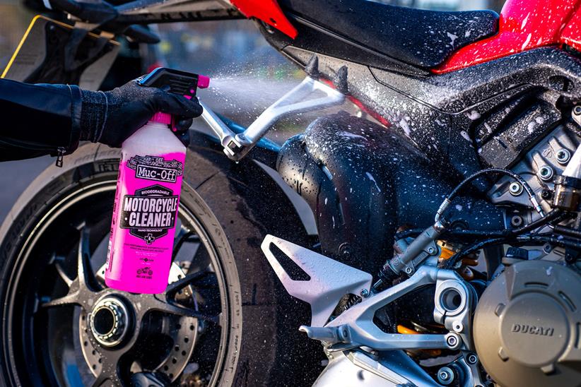 Muc-Off spray bottle being applied to a bike
