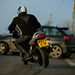 Biker skidding towards car
