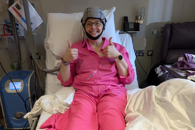 Emma in a hospital bed going through cancer treatment