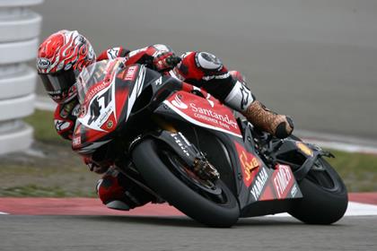 Injured Noriyuki Haga held off Troy Bayliss to take victory in race one at the nurburgring