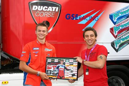 MCN's BSB Reporter Rob Hull presented Leon Camier with his momento from his first win at Snetterton