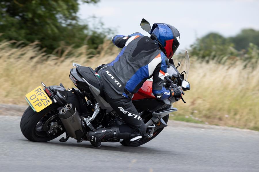 2025 Bimota Tesi H2 Tera, deep into a right turn on a country road 