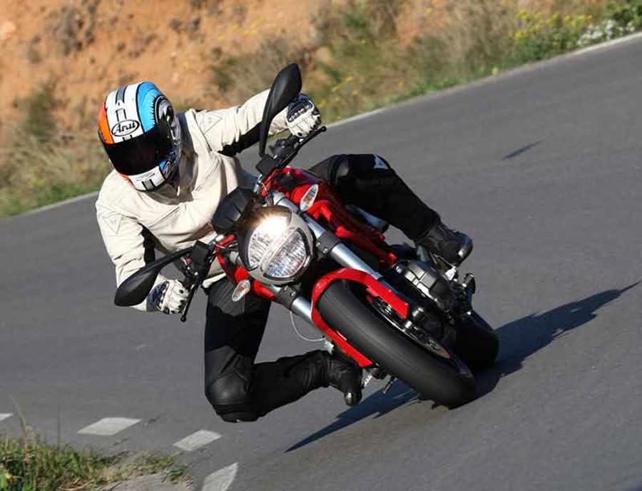 Ducati Monster 696 cornering quickly with knee almost down