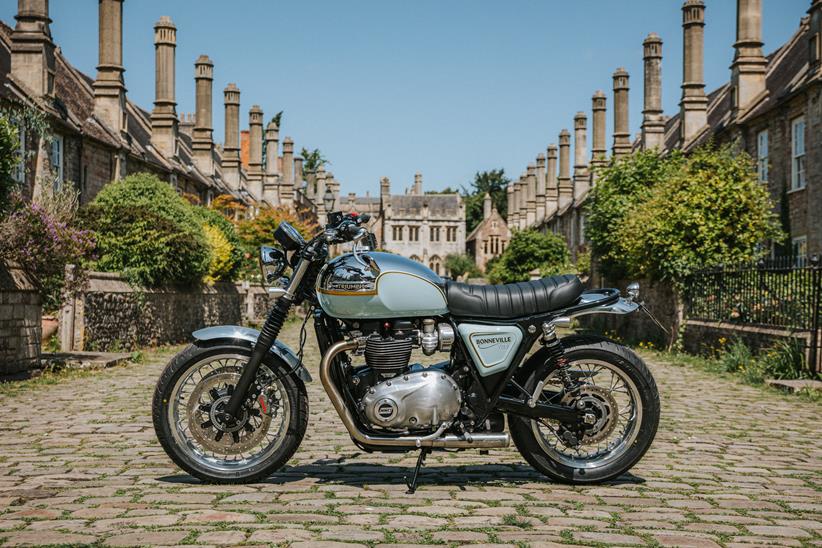 Custom Triumph Bonneville T120 parked up by old houses