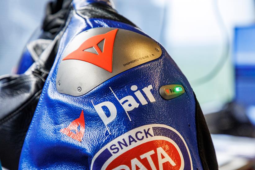 Dainese logo on race suit shoulder