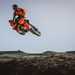KTM 690 SMC R jumping on a dirt track