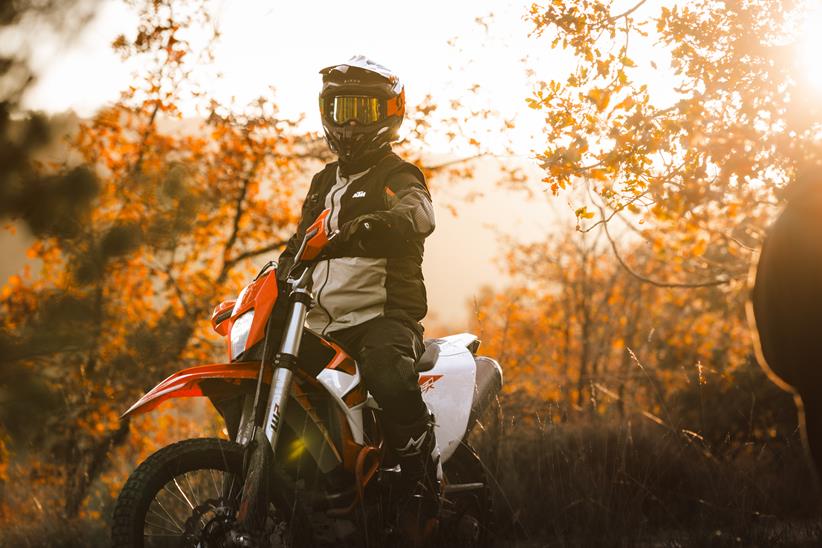 A rider stood over a KTM 690 Enduro R