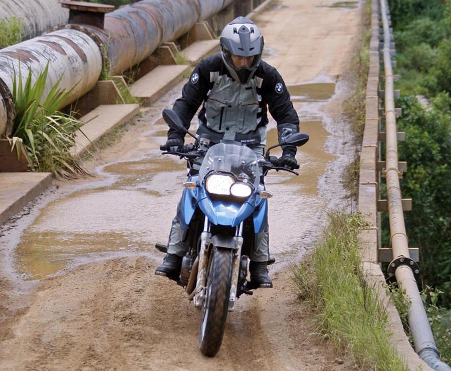 BMW F650GS in blue ridden through a puddle