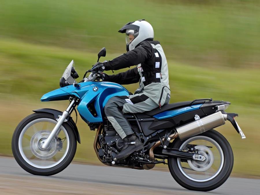 BMW F650GS side profile in blue ridden on road