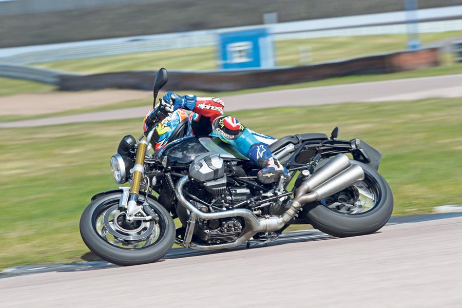 BMW R nine T cornering at speed with pegs down