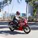 2022 Honda CBR300R - riding through hot city scene blue sky background