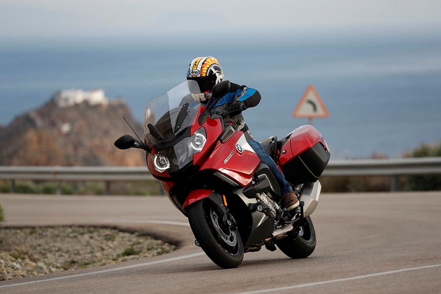 BMW K1600GT in red riding around a bend