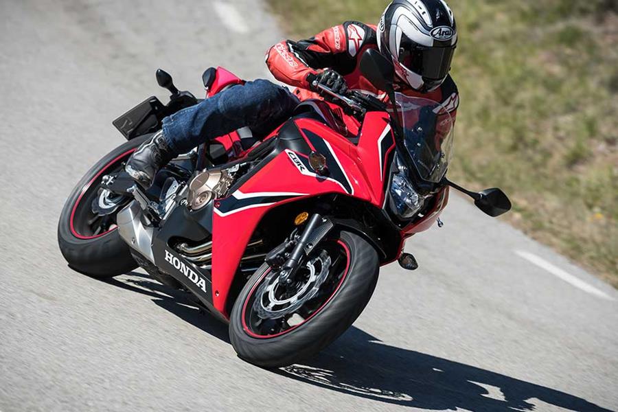 Honda CBR650F in black and red ridden quickly on the road