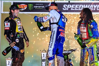 Swedish GP winner Nicki Pedersen (centre) deploys the champagne hose on runner-up Tai Woffinden (left). Photo: Andi Gordon/Monster