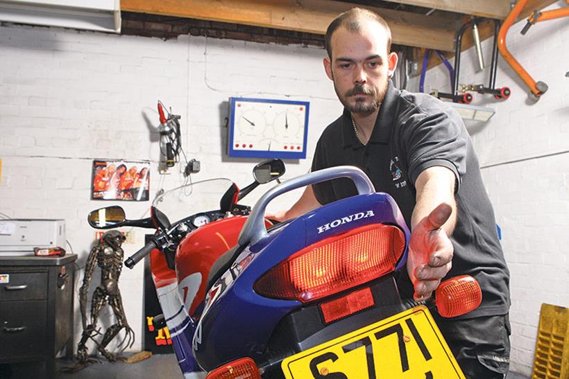 Checking motorcycle lights during an MoT test