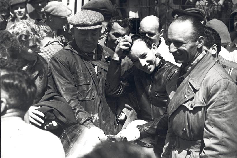 John Surtees surrounded by people