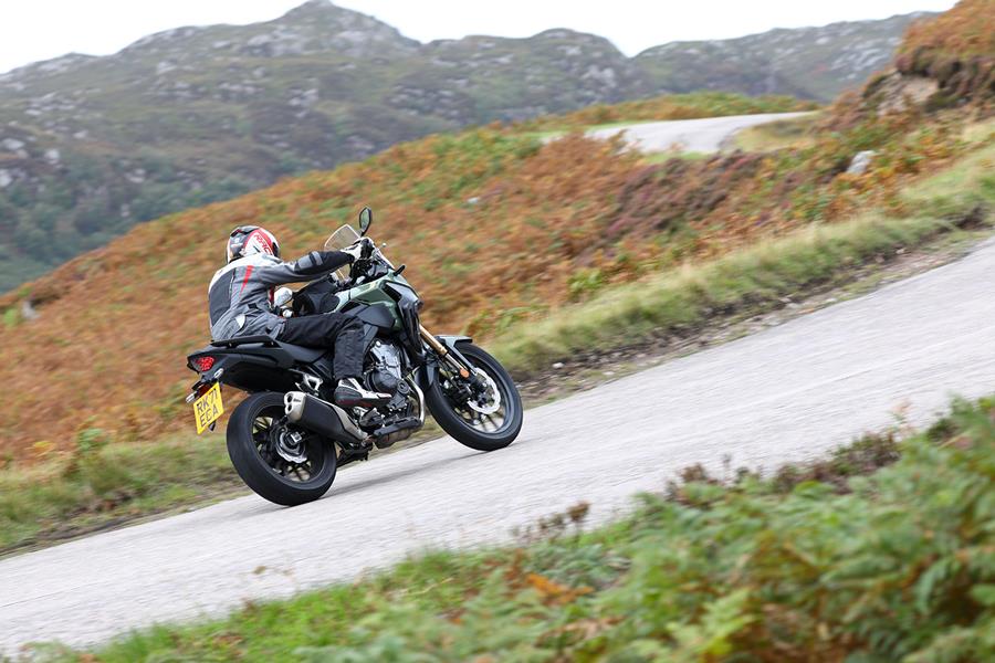 Riding the 2022 Honda CB500X up a hill 