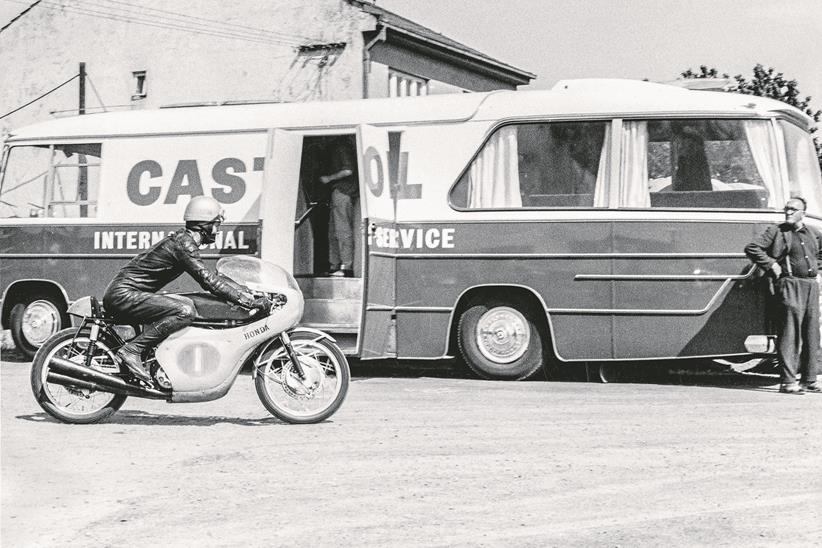 The great Jim Redman cruises through the paddock at Spa in the 1960s.