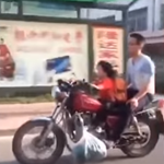 Toddler rides motorbike along busy streets with dad as pillion