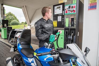 Filling up a petrol motorbike with fuel