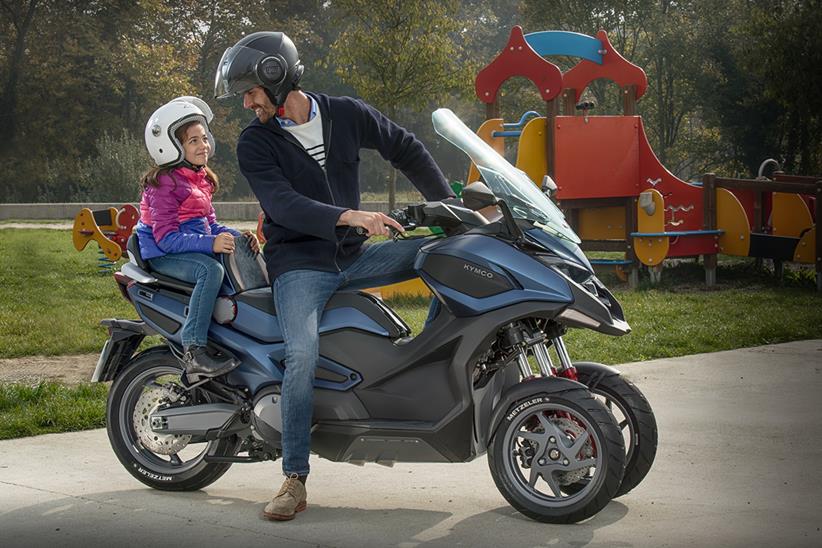 Kymco CV3 rider and passenger