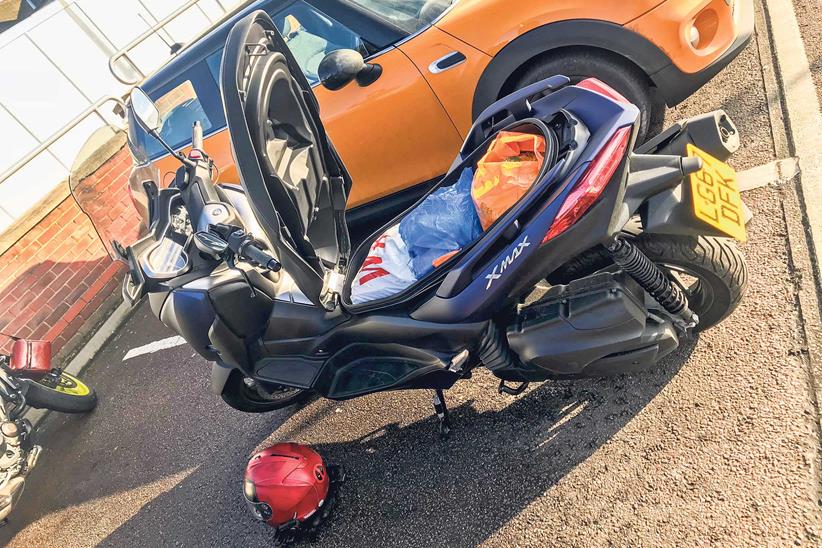 About three bags of shopping fit under the scooter's seat