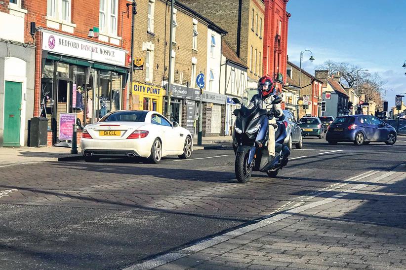 Maria riding through town on the XMAX 400 (Photo credit: Theo Martin)