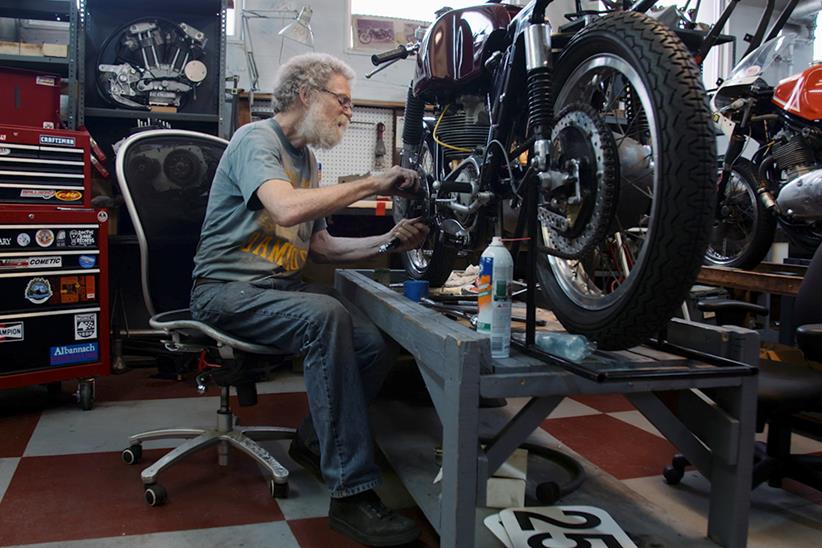 Dave Roper working on a bike at the 'Team Obsolete' workshop