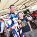 Troy Corser poses for photos with a young fan
