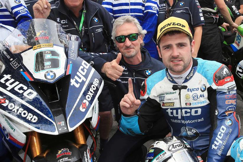 Dunlop celebrates with his team after victory in the 2018 Superbike TT 