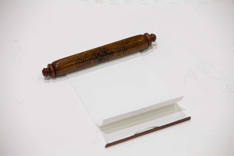 The baton has a scroll to sign your name