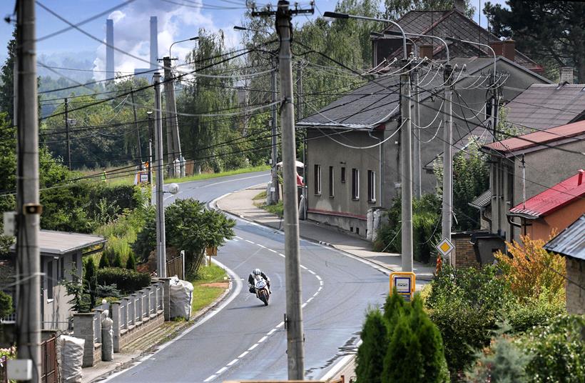 The Ostrava skyline behind a road racer